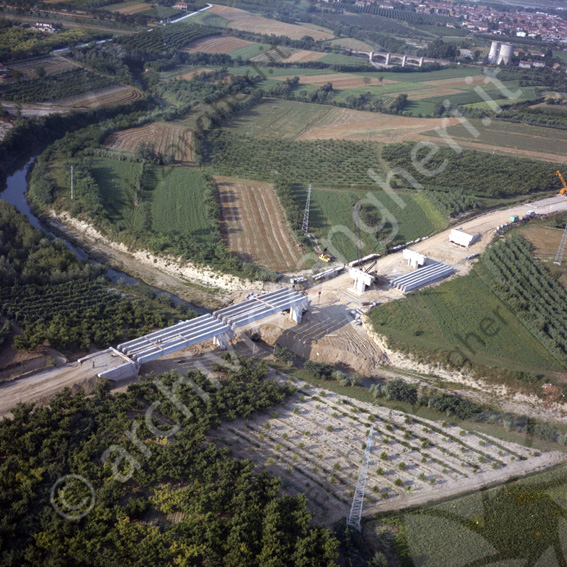 Aerea cantiere costruzione ponte sul Ronco campi travi fiume gru