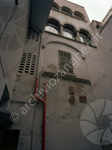 Cortile dietro chiesa S. Anna Muro tubature finestre ad arco stemmi