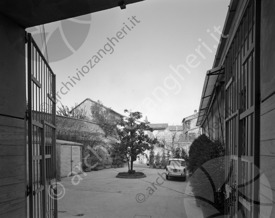Banca popolare di Cesena part. esterno interno cancello albero aiuola auto cortile vasi piante steccato 